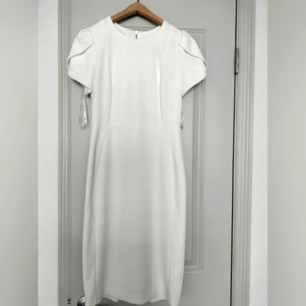 A beautiful white long dress, with cuffed shoulders. In good shape.